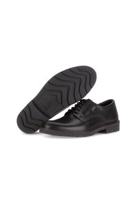 Zwarte leren schoenen met een ronde neus, vetersluiting, gestikte accenten en een gestructureerde zwarte rubberen zool met een golvend patroon.