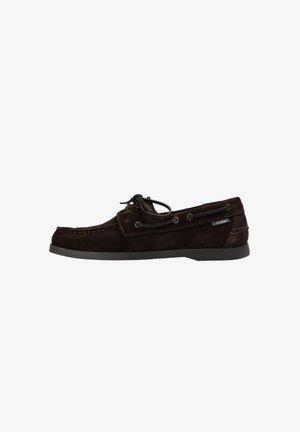 Brown suede boat shoe with a low profile, lace-up design, contrasting stitching, and a rubber sole. Features metal eyelets and a logo tag.