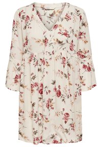 Vaaleanbeige mekko, jossa on V-muotoinen kaula-aukko ja kyynärpäihinsykköiset kellohihat. Mekossa on punaisia ja ruskeita kukkakuoseja. Pehmeä ja teksturoitu kangas.