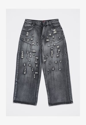 Jeans in denim nero a gamba larga con molteplici strappi orizzontali e toppe consumate sulla parte anteriore delle cosce e delle ginocchia.