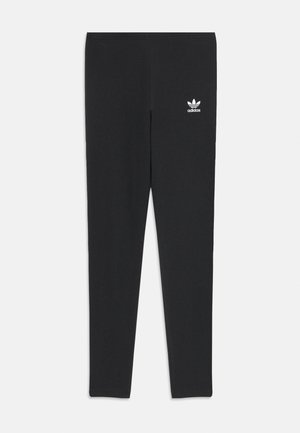 Leggings noirs en matériau doux et stretchy avec une texture côtelée. Comprend un petit logo blanc Adidas à l'avant.