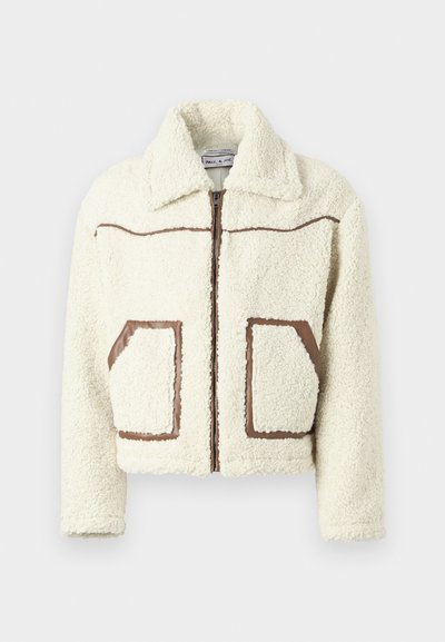 Cream-colored fleece jacket with a zip front, brown faux leather accents, and two patch pockets. Features a collared neckline.