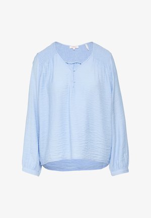 Blusa azzurro chiaro a maniche lunghe con un tessuto testurizzato, scollatura a V, dettaglio dei bottoni e spalle arricciate. Orlo arrotondato e polsini ripiegabili.