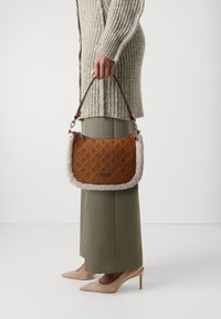 Guess DAVIKA HOBO - Handbag - cognac