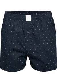 Boxer in cotone blu navy con chiusura a bottoni, vita elastica e piccoli motivi geometrici bianchi e blu chiaro su tutta la superficie.