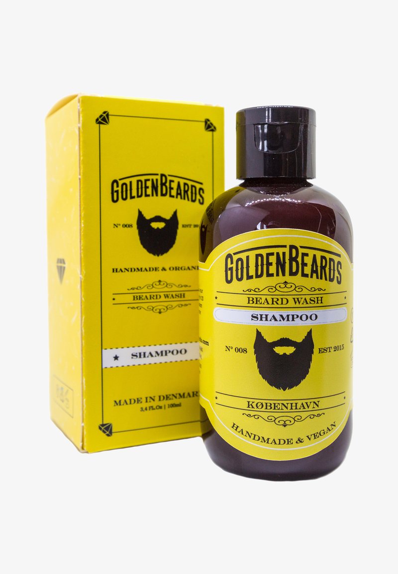 Brun glasflaske med en sort flip-kap, mærket med gule accenter og et sort bartsymbol, i en gul kasse mærket "Beard Wash."
