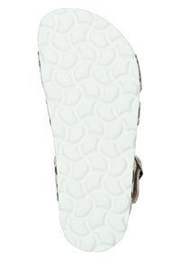 Suela de sandalia blanca con textura de patrón de onda curva; diseñada para ofrecer tracción. Se observa la sujeción de la correa en el lateral.