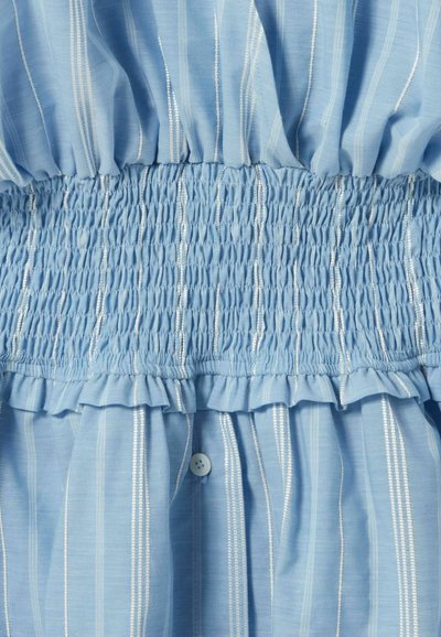 Tessuto azzurro chiaro con righe verticali bianche, caratterizzato da una fascia elastica arricciata in vita e un unico bottone bianco sotto la parte arricciata.