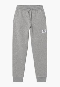 Grå bomulls-joggingbyxor med elastisk midjeband, dragsnodd, sidofickor, ribbad mudd och Calvin Klein Jeans-logotyp på vänster lår.