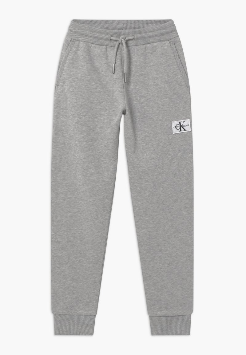 Grå bomulls-joggingbyxor med elastisk midjeband, dragsnodd, sidofickor, ribbad mudd och Calvin Klein Jeans-logotyp på vänster lår.