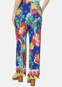 Cvečne široke hlače iz modrega blaga, s pisanimi vzorci rdečih, roza in zelenih cvetov, sproščenega kroja in elastičnim pasom.