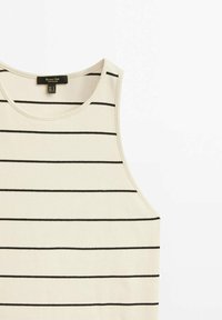 Débardeur couleur crème en tissu côtelé, avec des rayures noires horizontales. Design classique à encolure ronde avec des emmanchures larges.