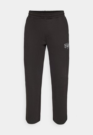 Schwarze Sweatpants mit elastischem Bund, seitlichen Taschen und weißem "City"-Text auf Oberschenkelhöhe vor einem schlichten weißen Hintergrund.