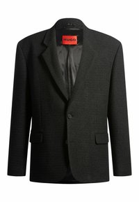 Blazer nero texturizzato a due bottoni con rever, tasche a patta e un'etichetta rossa HUGO all'interno del colletto.