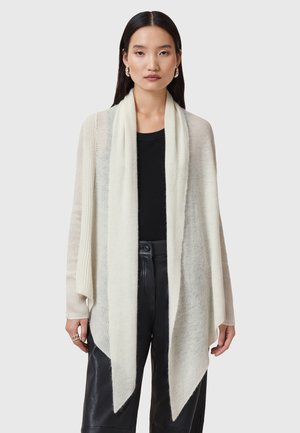 Lichtbeige gebreide cardigan met een open voorkant, lange mouwen en een gedrapeerde zoom. Textuur materiaal met subtiele strepen en een zachte afwerking.