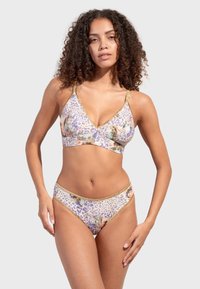 Floral patterned bikini set in soft, stretch fabric. Top features a V-neck design with gold accents; bottoms are low-rise with matching print.