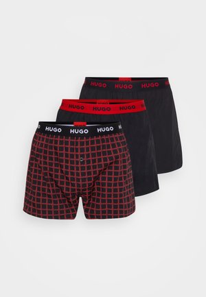 Tři páry boxerky: jedny červené a černé kostkované, dvě jednobarevné černé s červenými gumami v pase s logem "HUGO". Bavlněný materiál.