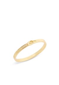 Gold-tone bangle bracelet with buckle detail and five small embedded crystals along textured surface, branded "COACH" inside.