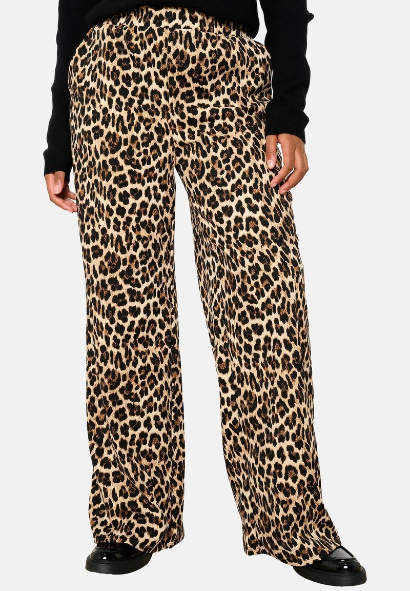 Leopard print wide-leg pants in tan and black fabric, featuring an elastic waistband. Paired with a black sweater and shiny black shoes.