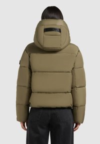Khaki puffer jacket with a hood, featuring horizontal quilted sections, elastic cuffs, and a logo accent on the back of the hood.