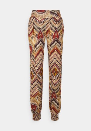 Bunt gemusterte Hose mit einem Zickzackdesign in Braun, Rot und Gelb. Elastischer Bund und Bündchen für eine lockere Passform.