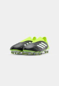 Black and lime green football cleats with a sleek design, featuring transparent studs and three white stripes on the sides.