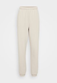 Licht beige sweatpants van zachte stof, met een elastische tailleband en boorden, en twee zijzakken. Glad textuur, ontspannen pasvorm.