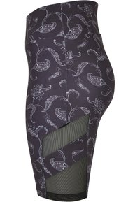 Gonna nera con motivo paisley grigio, caratterizzata da una vita alta e ritagli in rete sui lati per una maggiore traspirabilità.