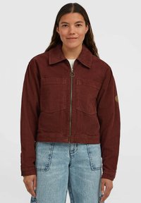 Rust-colored corduroy jacket featuring a zip front, two front pockets, a classic collar, and long sleeves with buttoned cuffs.