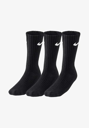 Calcetines de algodón negros de tipo crew con textura acanalada y un logo de swoosh blanco de Nike. Se venden en un paquete de tres.
