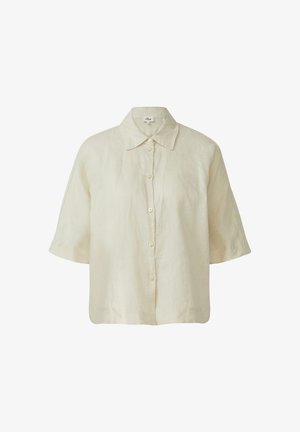 Světlý béžový lněný top s klasickým límečkem, krátkými rukávy a zapínáním na knoflíky v přední části. Měkká textura s volným střihem.