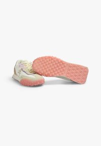 Sporty sneakers with a light yellow, cream, and pink color scheme; textured rubber sole features circular grips; multi-material upper.