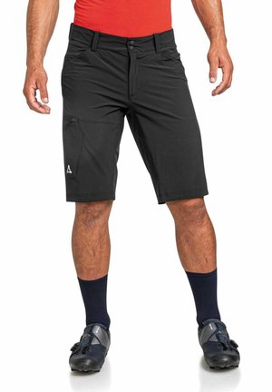 Schwarze Radsportshorts mit tailliertem Schnitt, ausgestattet mit einem Frontknopfverschluss, seitlichen Taschen und einem kleinen Logo am linken Bein.