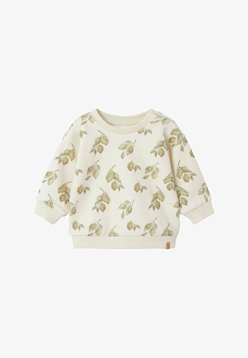 Gai bēšs džemperis ar lapu rakstu lēnās zaļās krāsās, ar ribotu apkakli un aprocēm, kā arī nelielu zīmola etiķeti sānos.