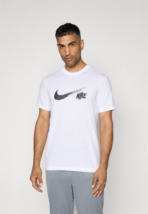White cotton t-shirt featuring a large black Nike logo on the chest, short sleeves, and a crew neck design. Smooth texture.