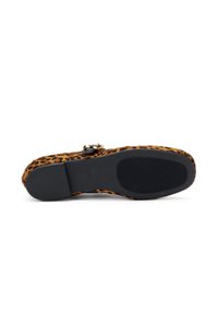 Sandalia de estampado de leopardo con una superficie texturizada y suela de goma negra. Presenta una hebilla metálica y una correa de cuero marrón en contraste.