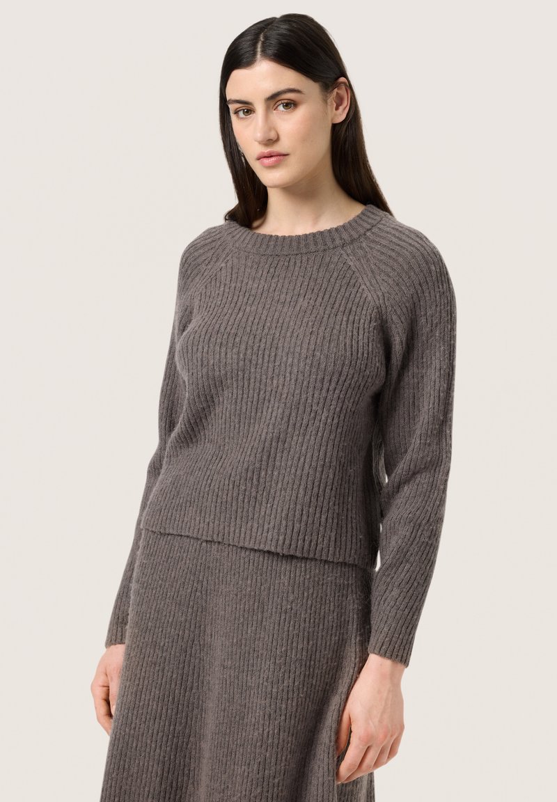 Gray ribbed knit sweater with a crew neckline and fitted design; features long sleeves and a slightly cropped hem for a modern look.