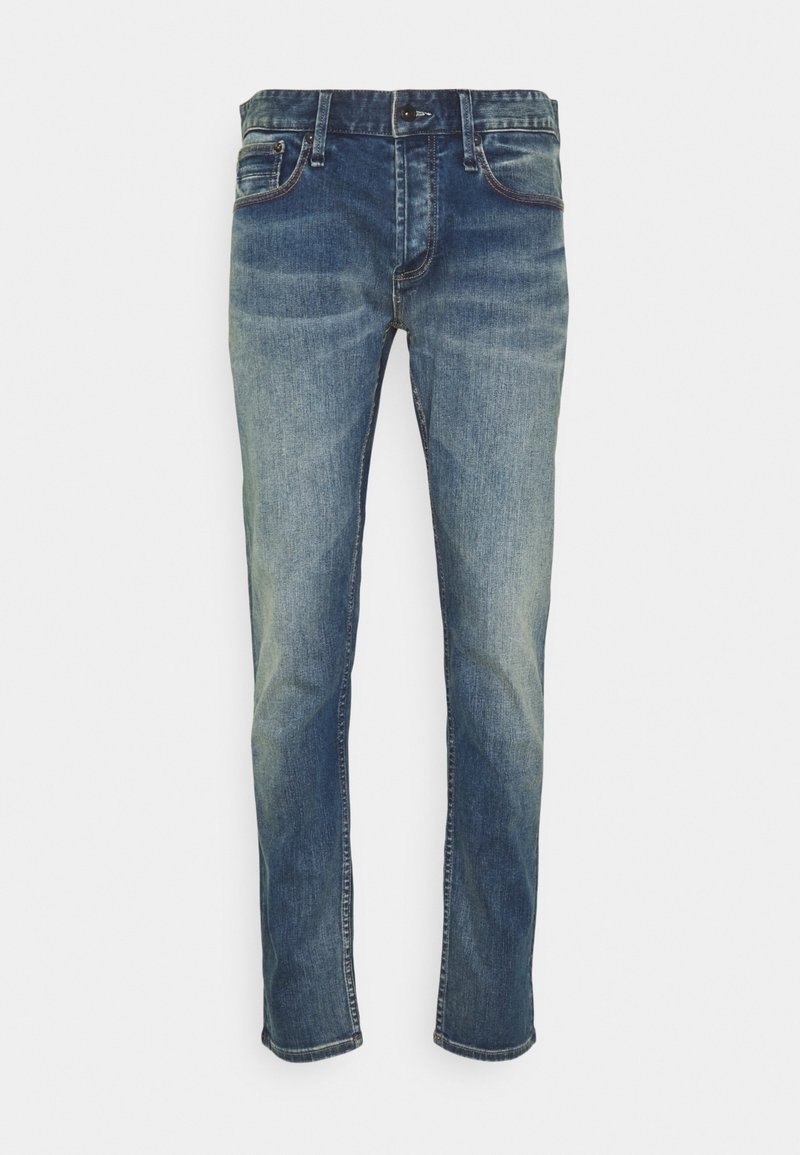 Blå jeans i denim med något blekt utseende, rak benstil, fem fickor och kontrasterande sömnadsdetaljer.