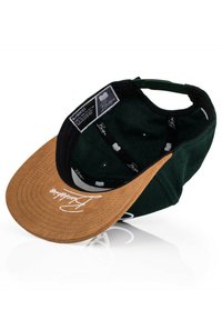 Green fabric cap with a brown, stitched brim. Features internal labels, black lining, and white script text on the brim.