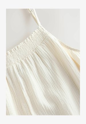 Šviesi grietinėlės spalvos be rankovių palaidinė su susiraukšlėjusia elastinga juostele aplink kaklą, pasižyminti sulankstytos tekstūros ir švelnios, lengvos medžiagos savybėmis.