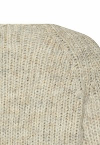 Licht beige gebreide trui stof met een geribbelde textuur en een subtiel patroon, met een zachte, licht gemeleerde uitstraling.