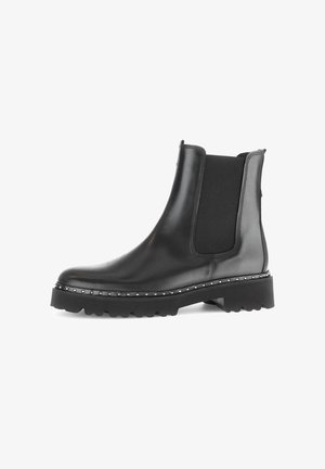 Black leather ankle boot featuring elastic side panels, a chunky sole, and studded accents along the outsole for added detail.