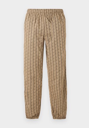 Pantaloni jogger beige con vita e caviglie elastiche, caratterizzati da un motivo geometrico ripetuto di forme stilizzate "B" marrone scuro.