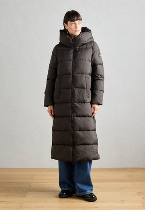 Long, dark gray puffer coat with a hood, featuring side pockets and a front zipper. The material is quilted for insulation and warmth.