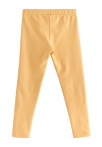 Gule leggings med en blød, glat tekstur. Har en elastisk talje og er i fuld længde uden mønstre eller udsmykninger.