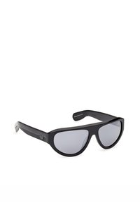 Lunettes de soleil noires oversize avec des montures épaisses et des verres teintés gris, comportant un petit logo Adidas sur les branches.