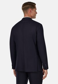 Tumed blazerd õhukesest kangast, struktureeritud lõikega, kahe nupuga kinnitusega, küljetaskudega ja detailse õmblusega varrukatel.