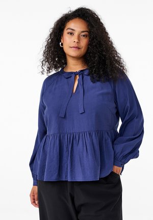 Marineblaue Bluse mit Schlüssel-ausschnitt und Bindearmband, langen Ärmeln und gesammeltem Peplum-Design. Weicher, glatter Stoff.