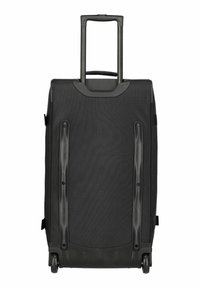Valigia nera con ruote, superficie in tessuto testurizzato, manico retrattile e forma aerodinamica. Dotata di due ruote che scorrono agevolmente.