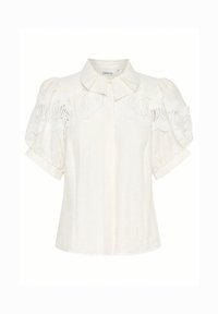 Blusa bianca in lino con scollatura a colletto, maniche corte a palloncino e dettagli in pizzo intricati lungo le spalle. Tessuto leggero e testurizzato.